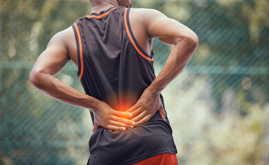 Athletic, fit man with lower back pain, outdoors hold and massages tired and strain muscles or...