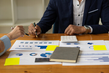 Asia business advisors meeting to analyze and discuss financial reports situation in the meeting room for financial investment advisors of businesses.