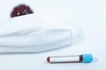 Blood sample test tube, face mask and Covid-19 cell