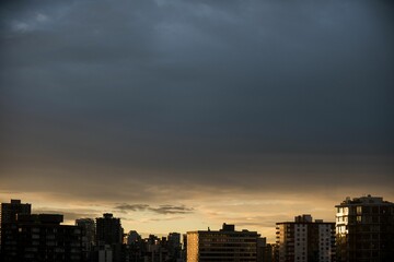 City against cloudy sky during sunset