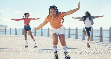Friends, fitness and roller skating at the beach in summer as a group of young gen z girls and boy...
