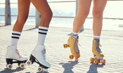 Roller skates or fun friends on promenade for summer holiday activity or travel outdoor. Cool, trendy or funky women skating legs in quad skating or rollerblades with sunshine, beach and ground
