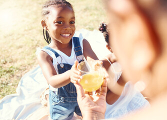 Happy girl, juice and smile in family picnic fun and joy in happiness on a warm summer day in nature. Black child smiling for fresh cold healthy beverage in the hot outdoors with parent and sibling