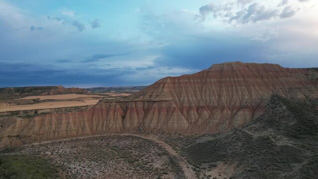 Aerial view of Bardenas Reales mountain landscape at sunset, Spain.