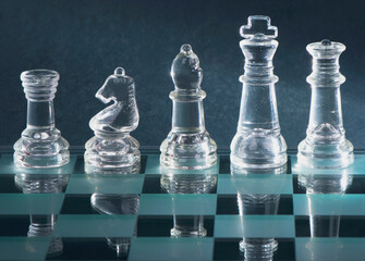 Glass chess is placed on black background