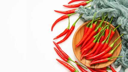 top view or flat lay group of red chili pepper in wood plate on white overhead background.                                                   