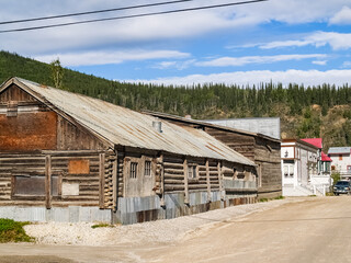 Log cabin style building in dusty town street in Yukon Territory, Dawson City.