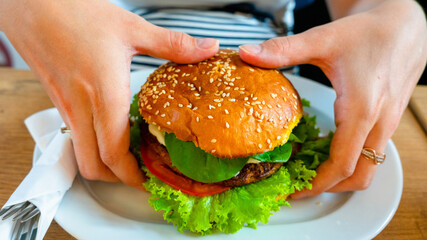 Veggie burger healthy vegan food. Salad, avocado, vegetable on vegetarian hamburger eating cute...