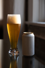Cold beer on reflective glass table
