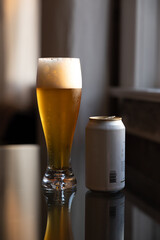 Cold beer on reflective glass table