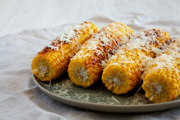 Homemade Garlic Parmesan Grilled Corn on a Plate, side view. Close-up.