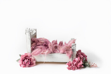 Pink fluff with pink flowers around bed that has crown hanging on post set scene for layer newborn...