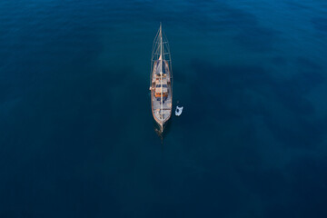 Wooden classic big gulet yacht is anchored on dark blue water. top view. Large wooden sailing gulet...