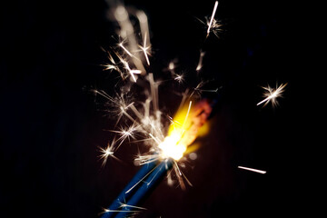 Sparkler is a type of handheld firework that burns slowly while emitting bright, intense colored flames, sparks and other effects