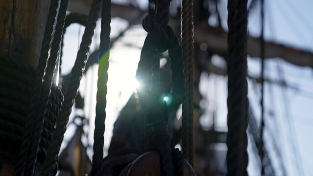 old warship rigging at sea concept with solar glare time passing concept shot