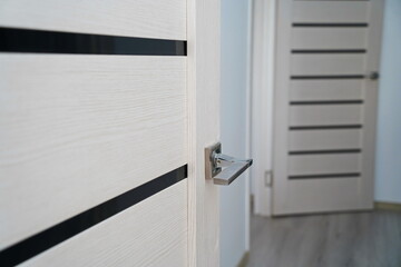 Metal handle of a wooden door in the kitchen.