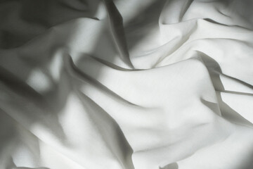 White drapery linen fabric background. Texture of the light surface of the fabric.