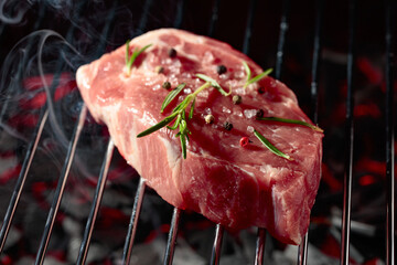 Raw steak on a grill.
