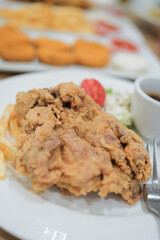A plate of chicken chop set come with french fries ,  coleslaw and carrot milk ice