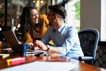 Colleagues in office. Businesswoman and businessman discussing work in office.