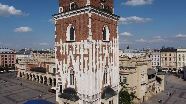 The Cloth Hall (Sukiennice) Market and St. Mary's Basilica (Bazylika Mariacka) in the City Centre of Krakow, Poland, a Polish cultural capital with renaissance architecture - 4K 30FPS Tracking Up