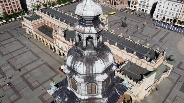 Town Hall Tower (Wieża Ratuszowa) in the main square  - City Centre flyover of Krakow, Poland, a Polish cultural capital, with medieval and renaissance architecture - 4K 30FPS Tracking Down Close Up