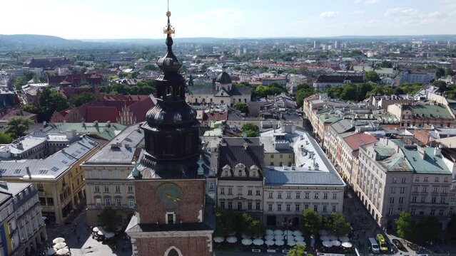 Town Hall Tower (Wieża Ratuszowa) in the main square  - City Centre flyover of Krakow, Poland, a Polish cultural capital, with medieval and renaissance architecture - 4K 30FPS Tracking Down Close Up