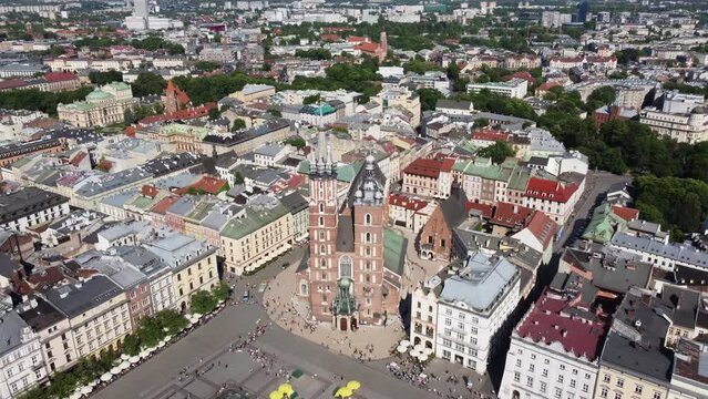 St. Mary's Basilica (Bazylika Mariacka), Clock Tower at the Main Square in Krakow, Poland, a Polish cultural capital, with medieval and renaissance architecture - 4K 30FPS Smooth Tracking Left