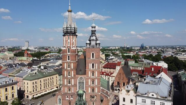 St. Mary's Basilica (Bazylika Mariacka), Clock Tower at the Main Square in Krakow, Poland, a Polish cultural capital, with medieval and renaissance architecture - 4K 30FPS Smooth Tracking Up