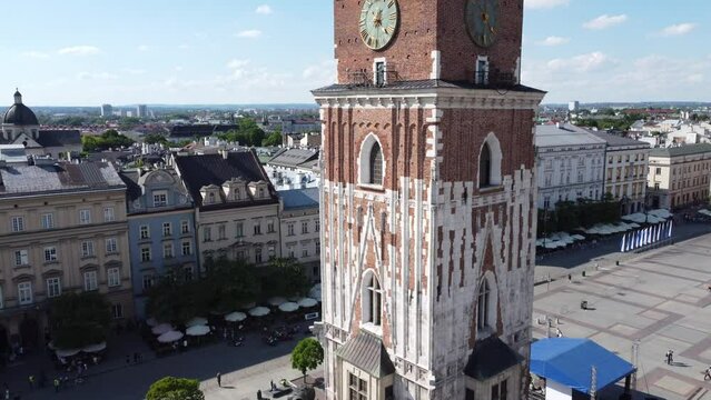 Town Hall Tower (Wieża Ratuszowa) in the main square  - City Centre flyover of Krakow, Poland, a Polish cultural capital, with medieval and renaissance architecture - 4K 30FPS Smooth Tracking Forwards