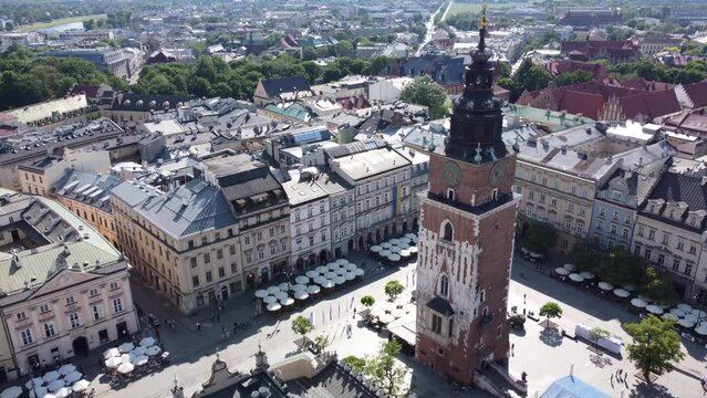 Town Hall Tower (Wieża Ratuszowa) in the main square  - City Centre flyover of Krakow, Poland, a Polish cultural capital, with medieval and renaissance architecture - 4K 30FPS Smooth Tracking Forwards