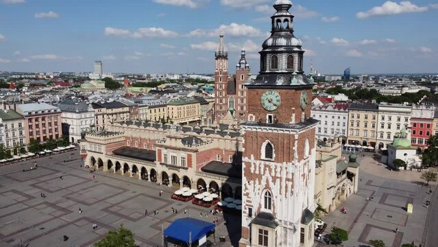 The Cloth Hall (Sukiennice) Market and St. Mary's Basilica (Bazylika Mariacka) in the City Centre of Krakow, Poland, a Polish cultural capital with renaissance architecture - 4K 30FPS Tracking Left