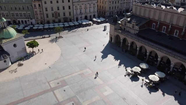 The Cloth Hall (Sukiennice) Market and St. Mary's Basilica (Bazylika Mariacka) in the City Centre of Krakow, Poland, a Polish cultural capital with renaissance architecture - 4K 30FPS Tracking Forward