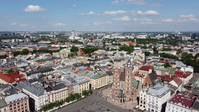 The Cloth Hall (Sukiennice) Market and St. Mary's Basilica (Bazylika Mariacka) in the City Centre of Krakow, Poland, a Polish cultural capital with renaissance architecture - 4K 30FPS Tracking Forward