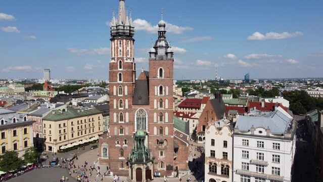 St. Mary's Basilica (Bazylika Mariacka), Clock Tower at the Main Square in Krakow, Poland, a Polish cultural capital, with medieval and renaissance architecture - 4K 30FPS Smooth Tracking Down