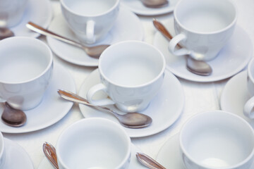 White tea cups with spoons