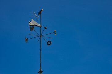 wind rose and weather vane on the blue sky
