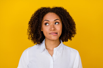 Photo of unsure uncertain wavy hairdo lady consider doubt dilemma look promo empty space isolated on yellow color background