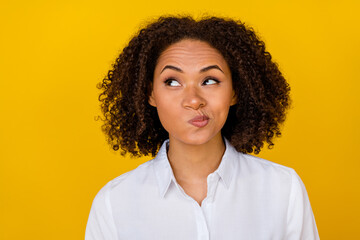 Close up photo of cute mischief funky lady have creative idea hmm decide look empty space isolated on yellow color background
