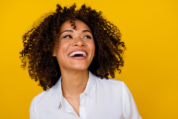 Photo of nice cute positive woman with curly hairstyle dressed white blouse laughing look empty...