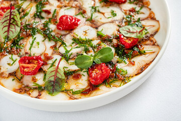 octopus carpaccio with tomato and herb