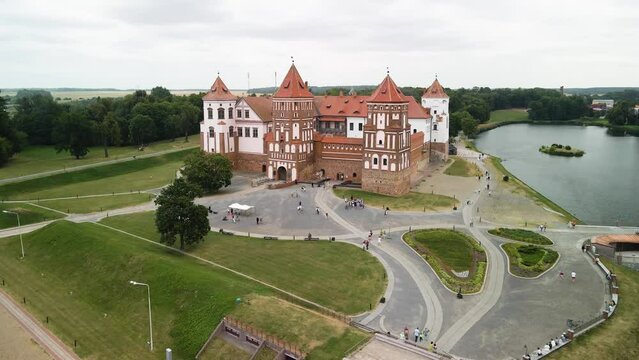 Aerial shot closing in on the mir castle found in mir city on a cloudy afternoon