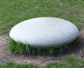 round stone in park at dry sunny summer day