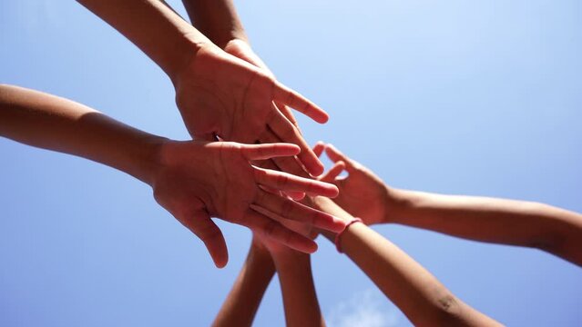 Children's hands are raised together, unity building, helping each other, competition, 4K solution