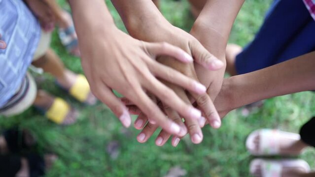 Children's hands unite, unity building, helping each other, competition