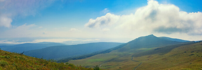 Naklejka na ściany i meble Beautiful panorama of the Carpathian Mountains with soft clouds. Summer mountain landscape