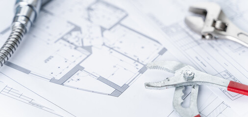 Plumbing project in house.Drawing,diagrams,plan of water supply of apartment,building.Man repairer...