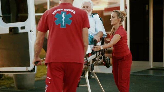 Sequence of shots of team of paramedics transporting old patient on stretcher and loading him into ambulance, then he starts to drive