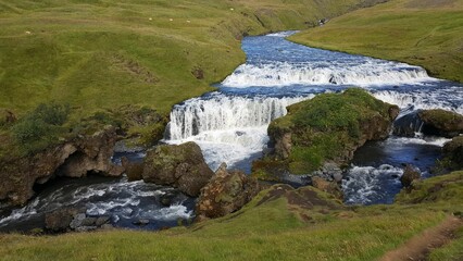 Fototapeta premium Typical Waterfall in Iceland with a beautiful Rainbow