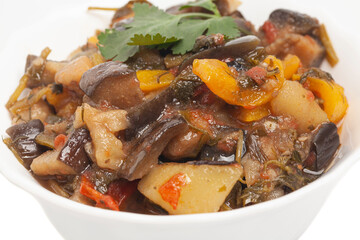 Ajab sandal. Salad with meat and grilled vegetables on white round plate isolated on white background. Diet conception